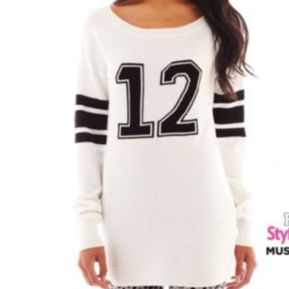 White sweater with black number and stripe detail
